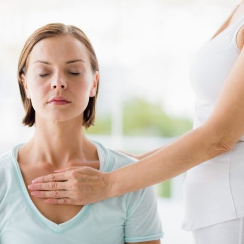 Young woman receiving masaage from masseur