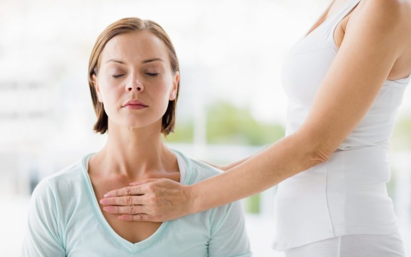 Young woman receiving masaage from masseur