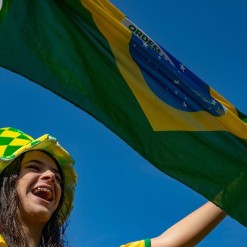 Brazilian fan celebrating and cheering for the Brazil national team at the World Cup.