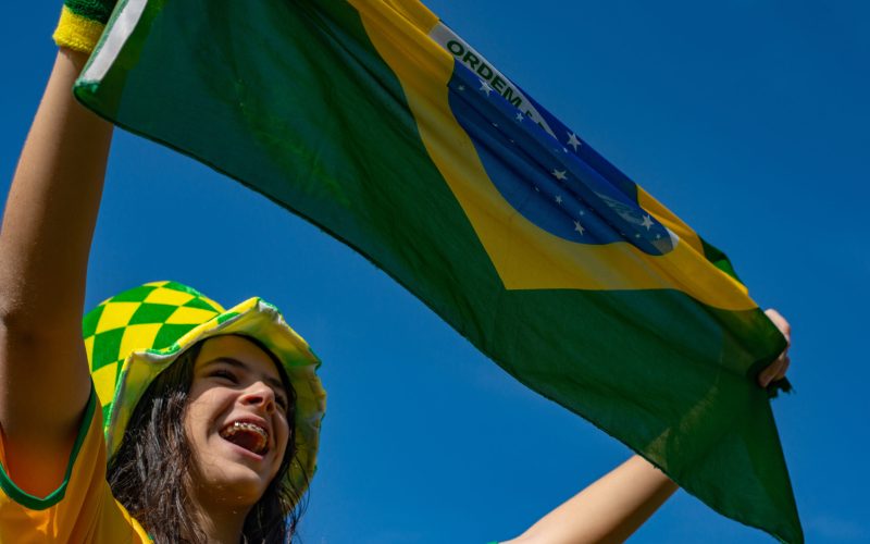 Brazilian fan celebrating and cheering for the Brazil national team at the World Cup.