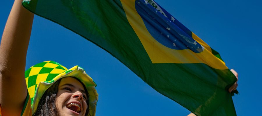 Brazilian fan celebrating and cheering for the Brazil national team at the World Cup.