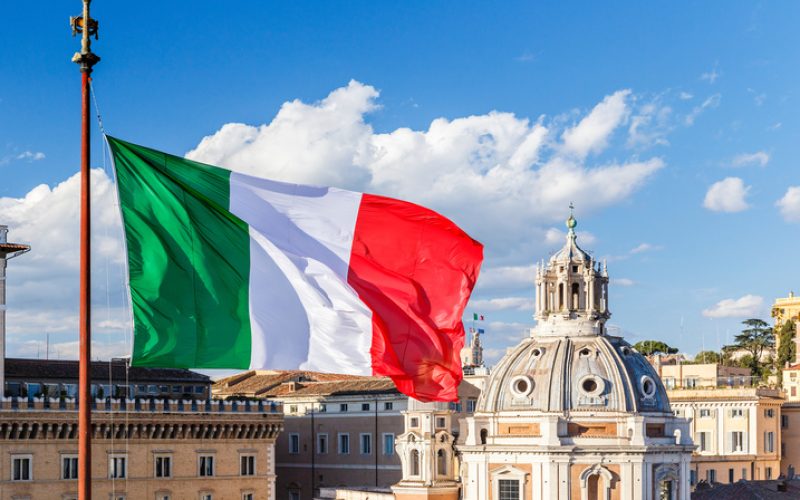 Italian flag on the background of the Cathedral and the blue sky
