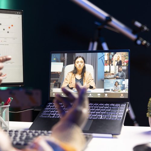 African american man employee having a video call with colleagues while working from home office. Coworkers engaged in a discussion utilizing technology for virtual communication.