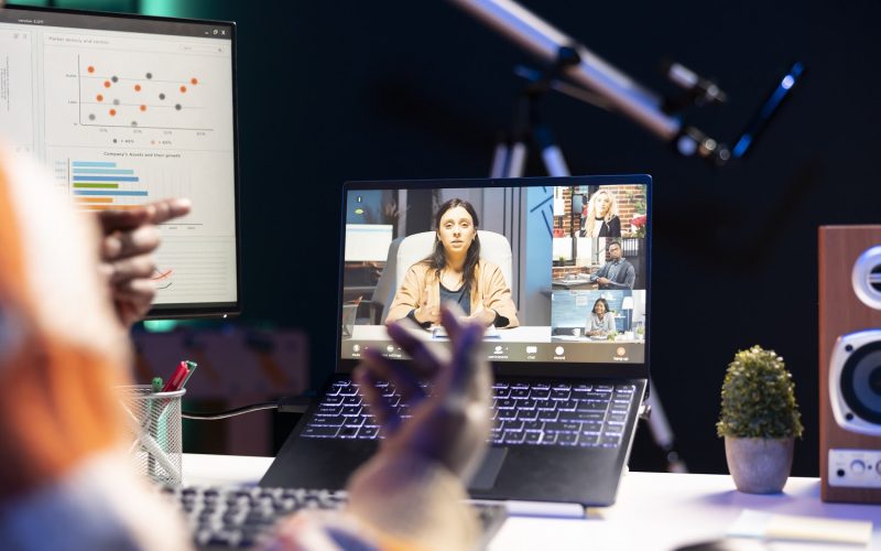 African american man employee having a video call with colleagues while working from home office. Coworkers engaged in a discussion utilizing technology for virtual communication.