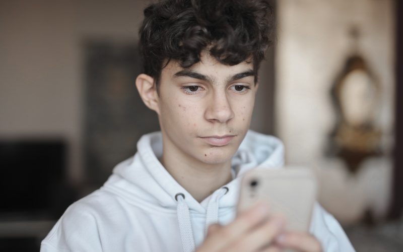 young guy uses a smartphone