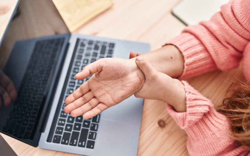 Young beautiful hispanic woman ecommerce business worker suffering for wrist pain at office